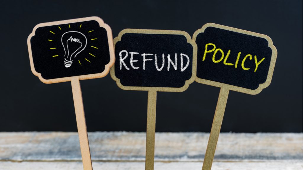 3 small signs advertise a refund policy.  DealDash offers a refund guarantee for new customers.