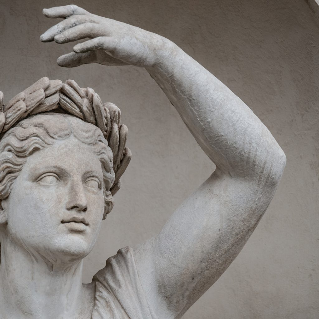 A renaissance-era statue of a woman gazes forward. 