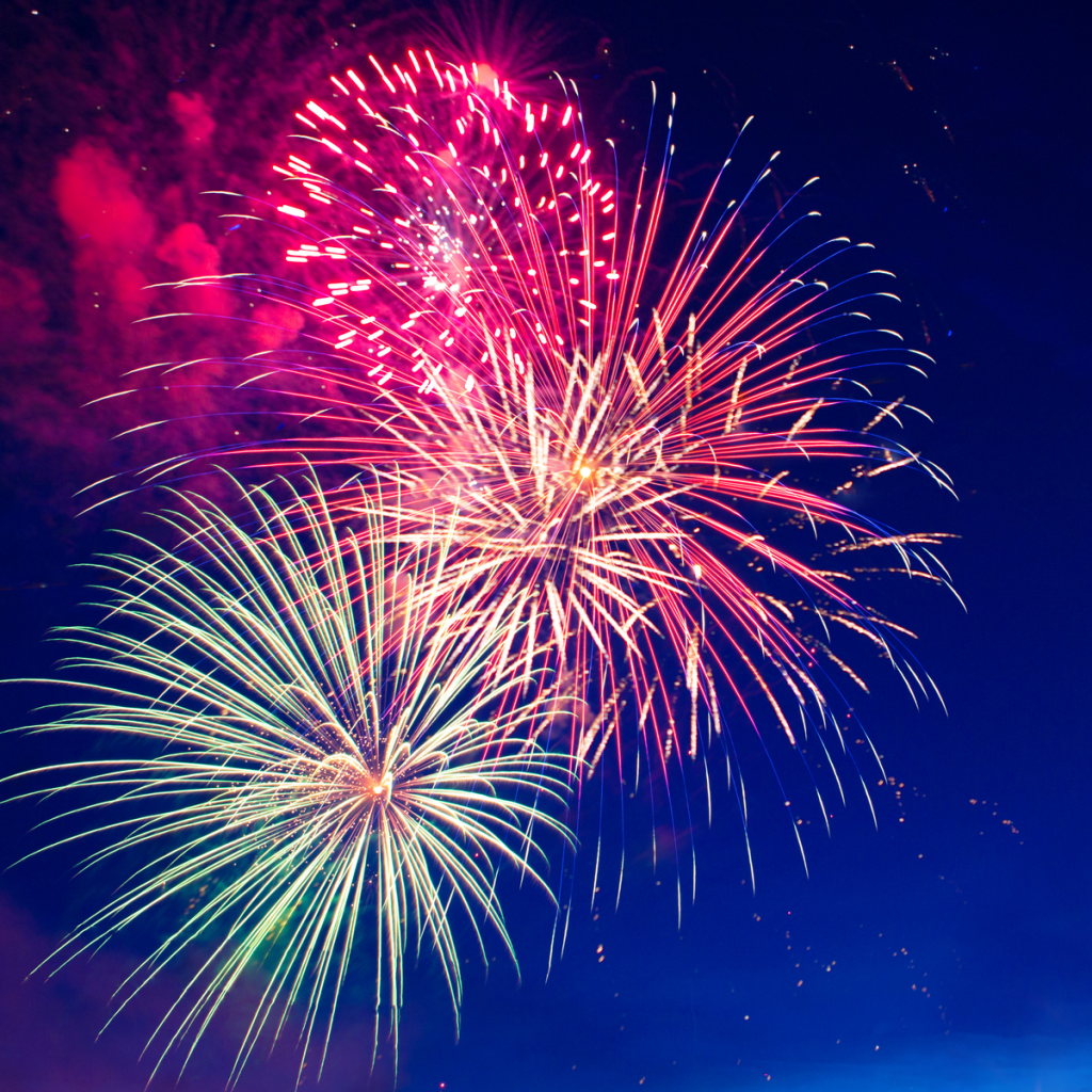 Beautiful fireworks fill the night sky and give a celebratory atmosphere. 