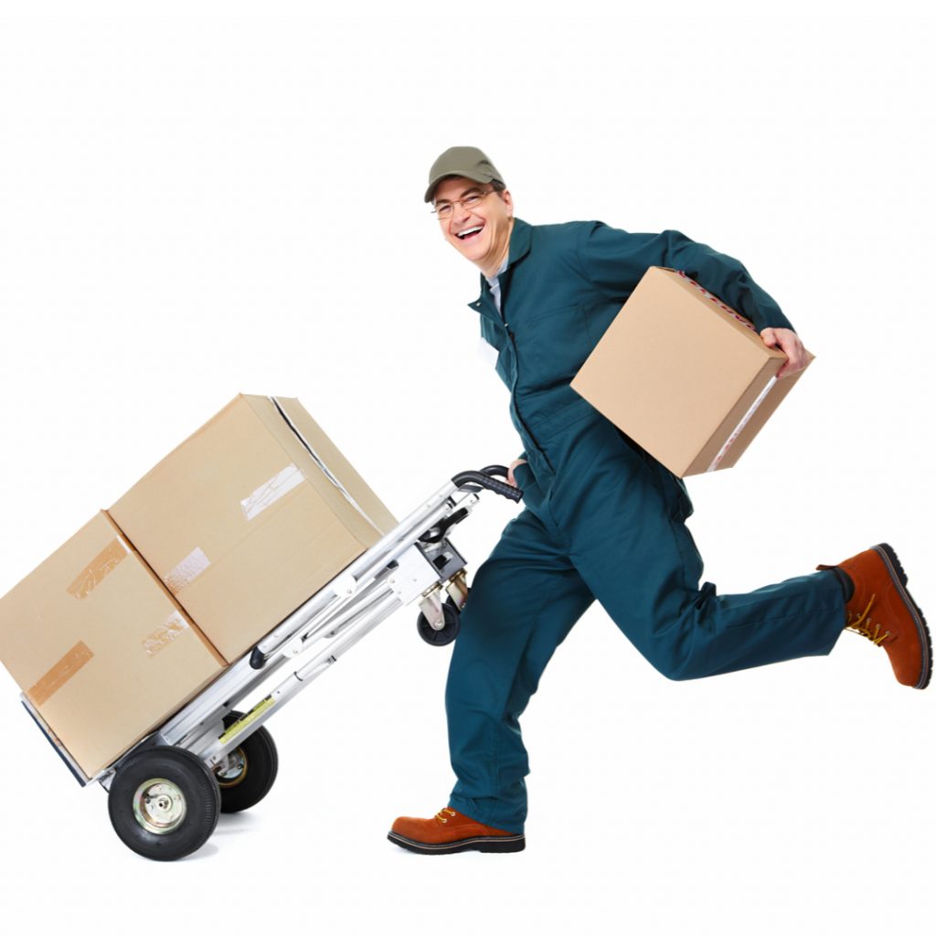 A worker runs to move several boxes out the door of a busy warehouse!