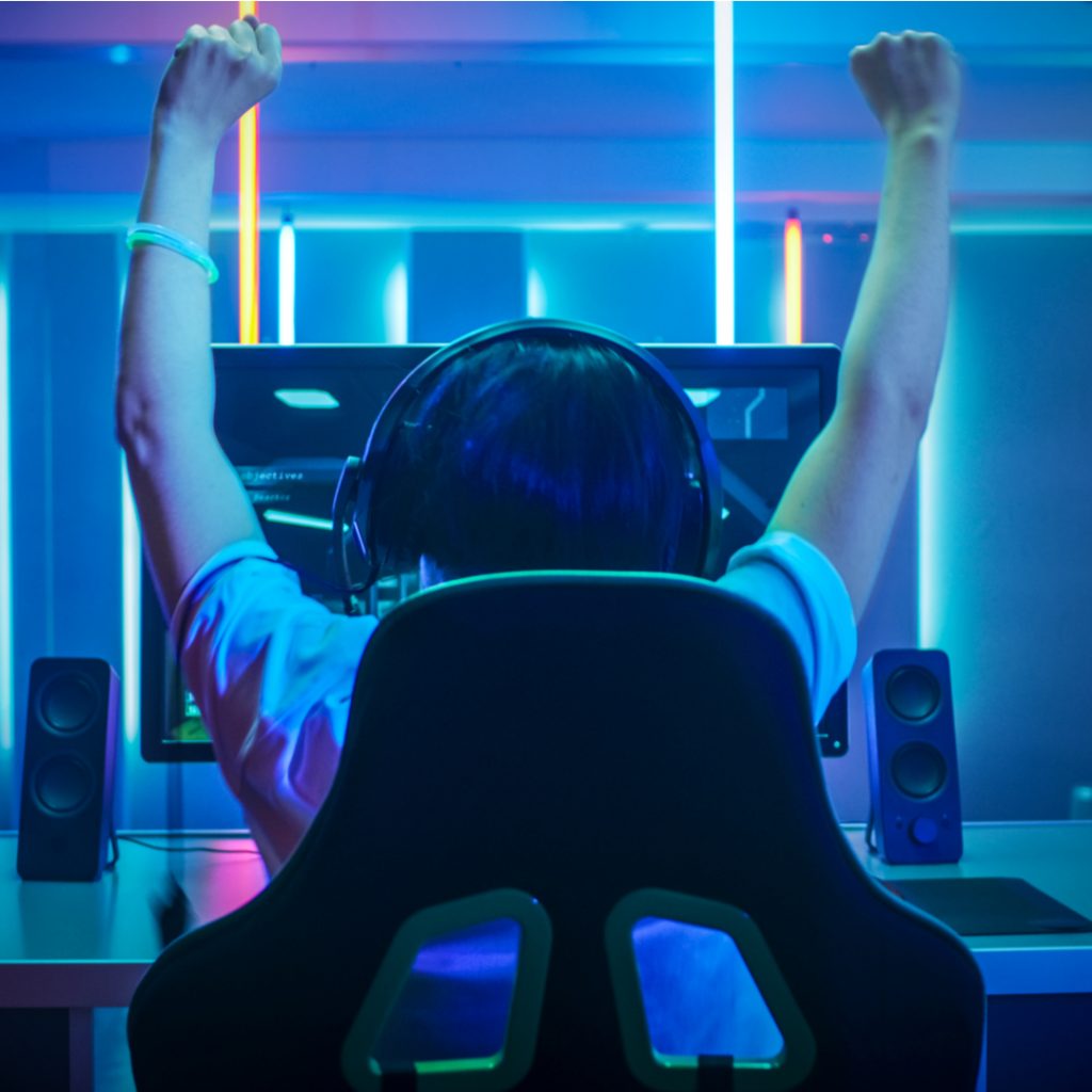 A gamer cheers in victory after a professional online gaming match.