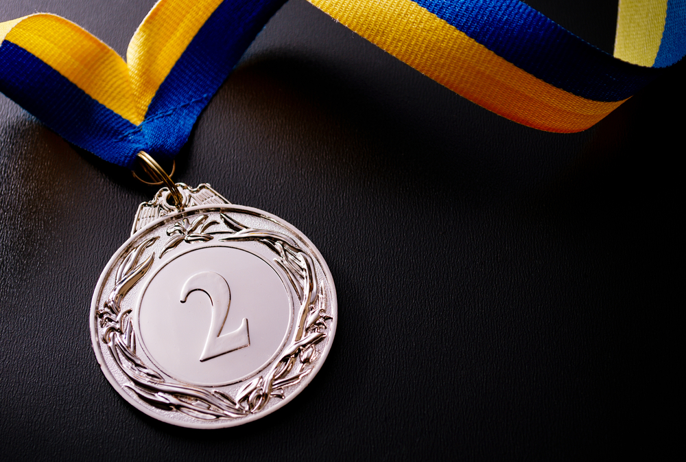 A silver medal sits as a proud reward for second place.